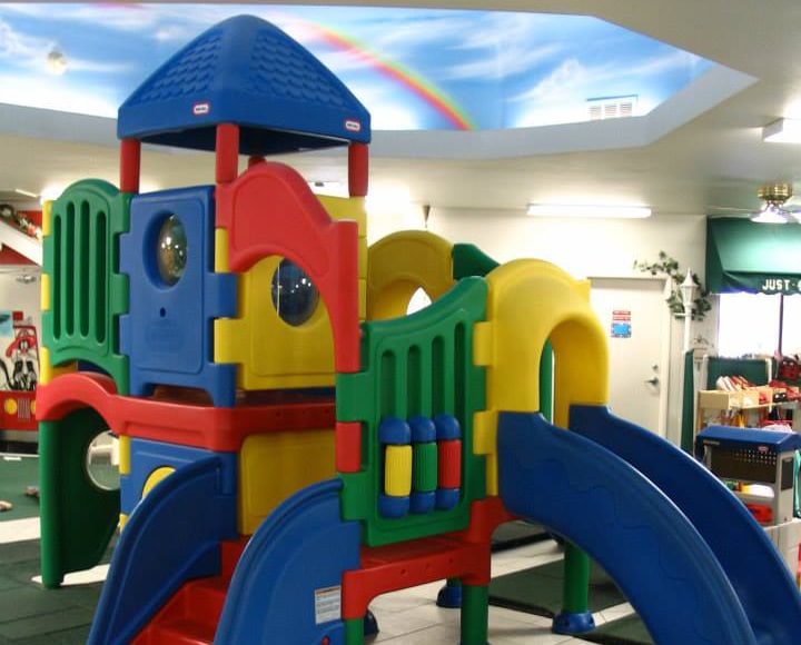 Colorful plastic indoor playhouse with slide at a Preschool & Daycare Serving Hesperia, CA