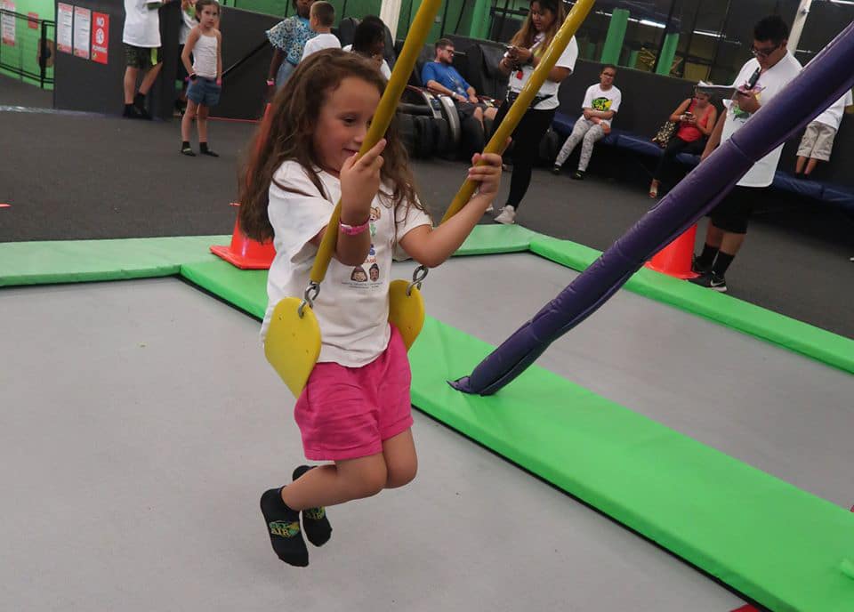 Young little girl on a swing in a playground at a Preschool & Daycare Serving Hesperia, CA