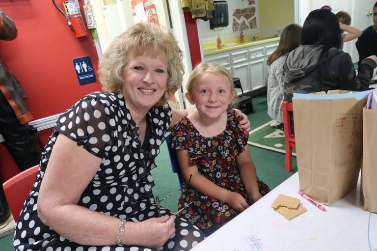 Happy mom and daughter wearing a dotted dress for mom and flower printed dress at a Preschool & Daycare Serving Hesperia, CA