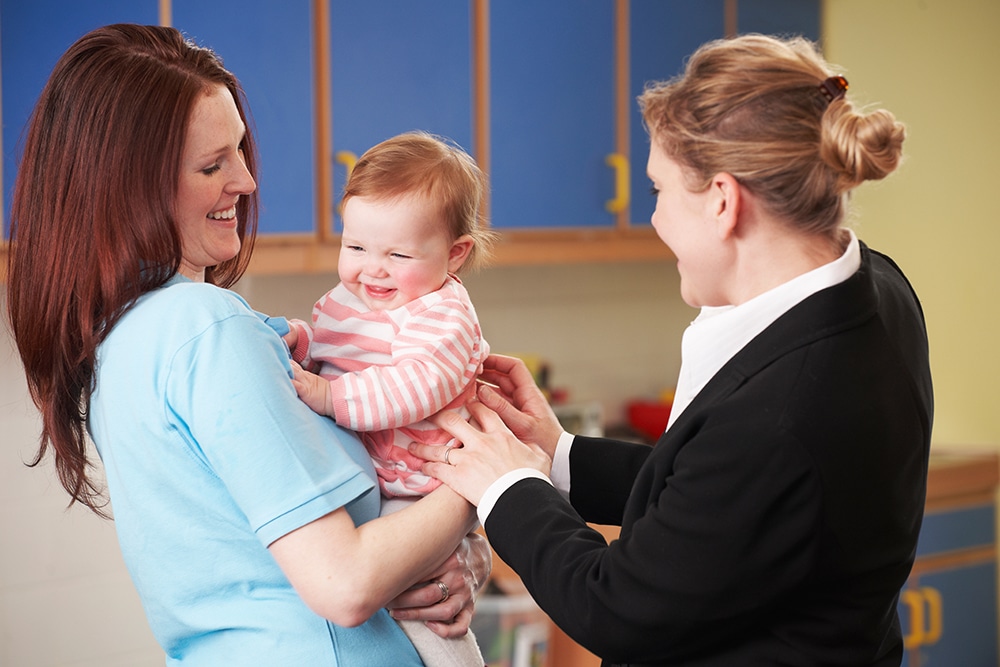 Working Mother Dropping Child Off At Nursery at a Preschool & Daycare Serving Hesperia, CA