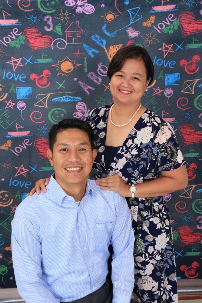 Happy owners on colorful chalk design wall background at a Preschool & Daycare Serving Hesperia, CA